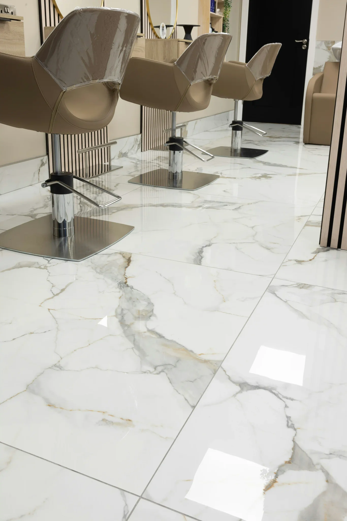 Glossy Calacatta gold porcelain tile floor installed in an Oak Park commercial space