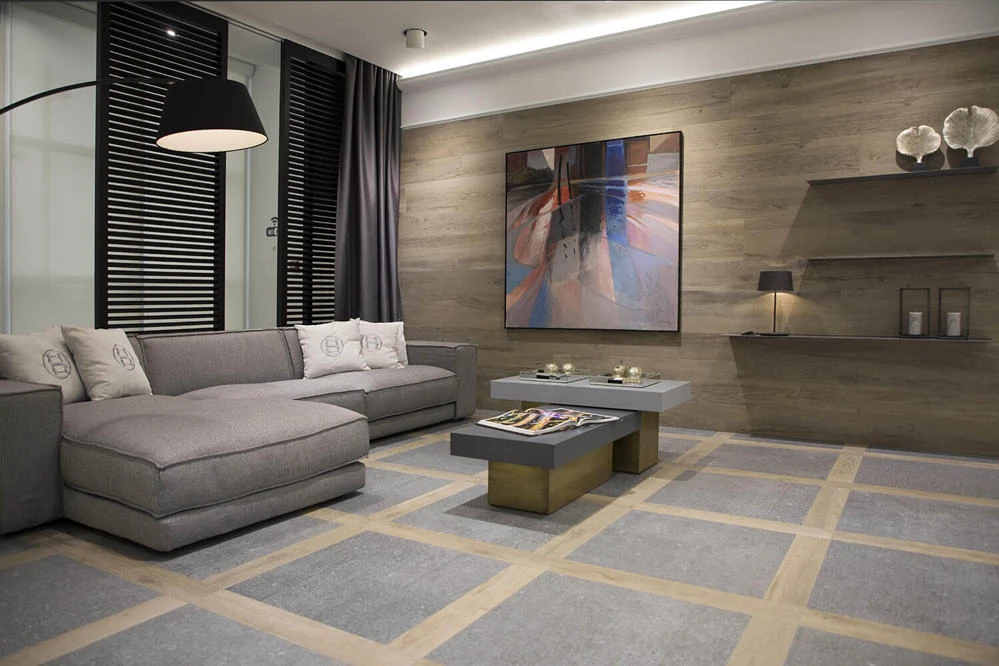 Custom two-tone floor tile layout with wood-paneled accent wall in a Tahoe Park residential interior