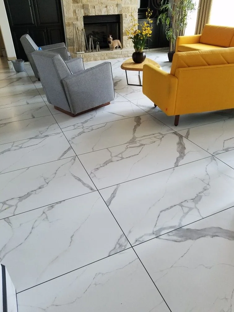 Glossy white Calacatta marble porcelain floor tiles in a residential living room